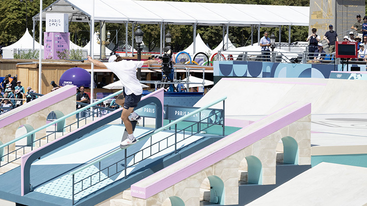 Skatebaorder does nosegrind at the Olympics