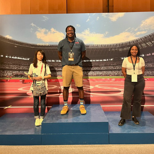 Man stands on stage with two women