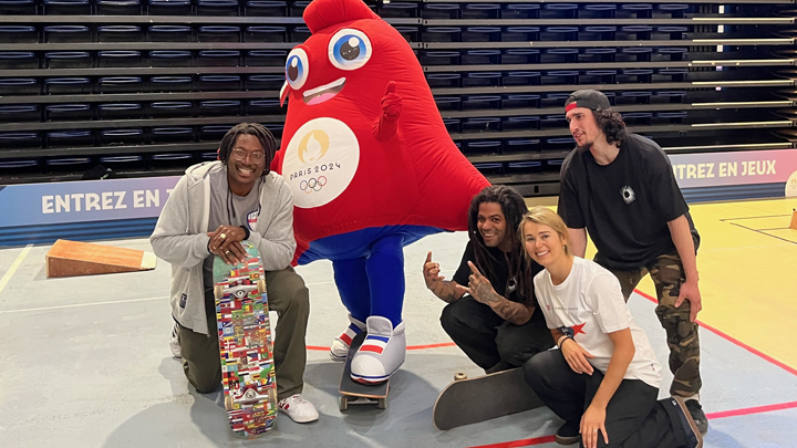 groups of skaters pose with Olympics mascot