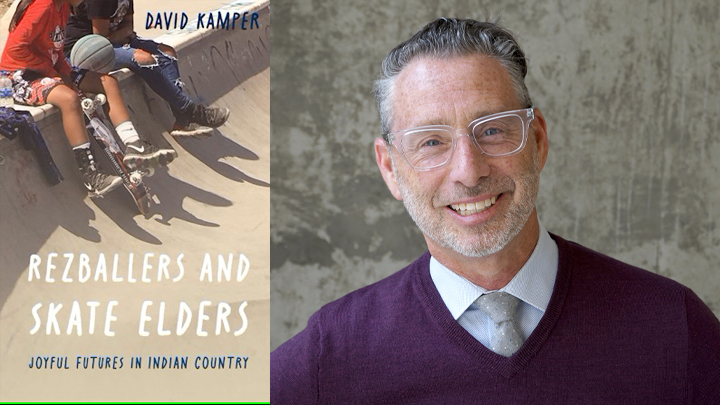 man smiling next to book cover with skateboarders